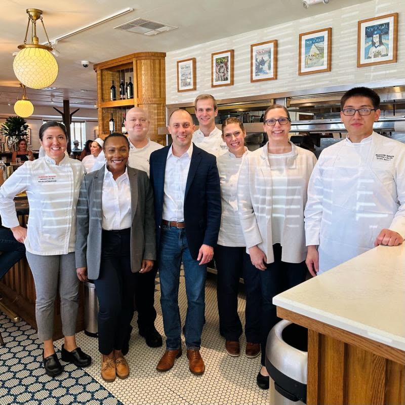 Jon Peck standing with members of the Hudson House team, chefs and managers, inside the restaurant
